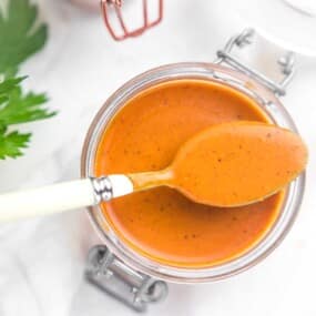 Enchilada sauce recipe with a spoon on a jar.