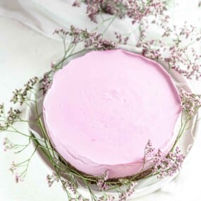 Blueberry Cheesecake on a white plate with flowers.