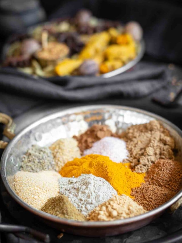 Spices in a metal bowl on a table.