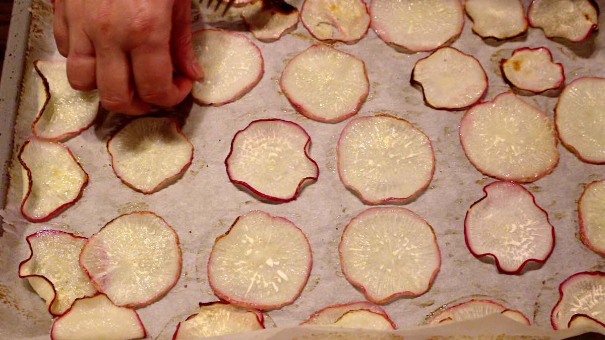 Sliced radishes on a baking sheet.