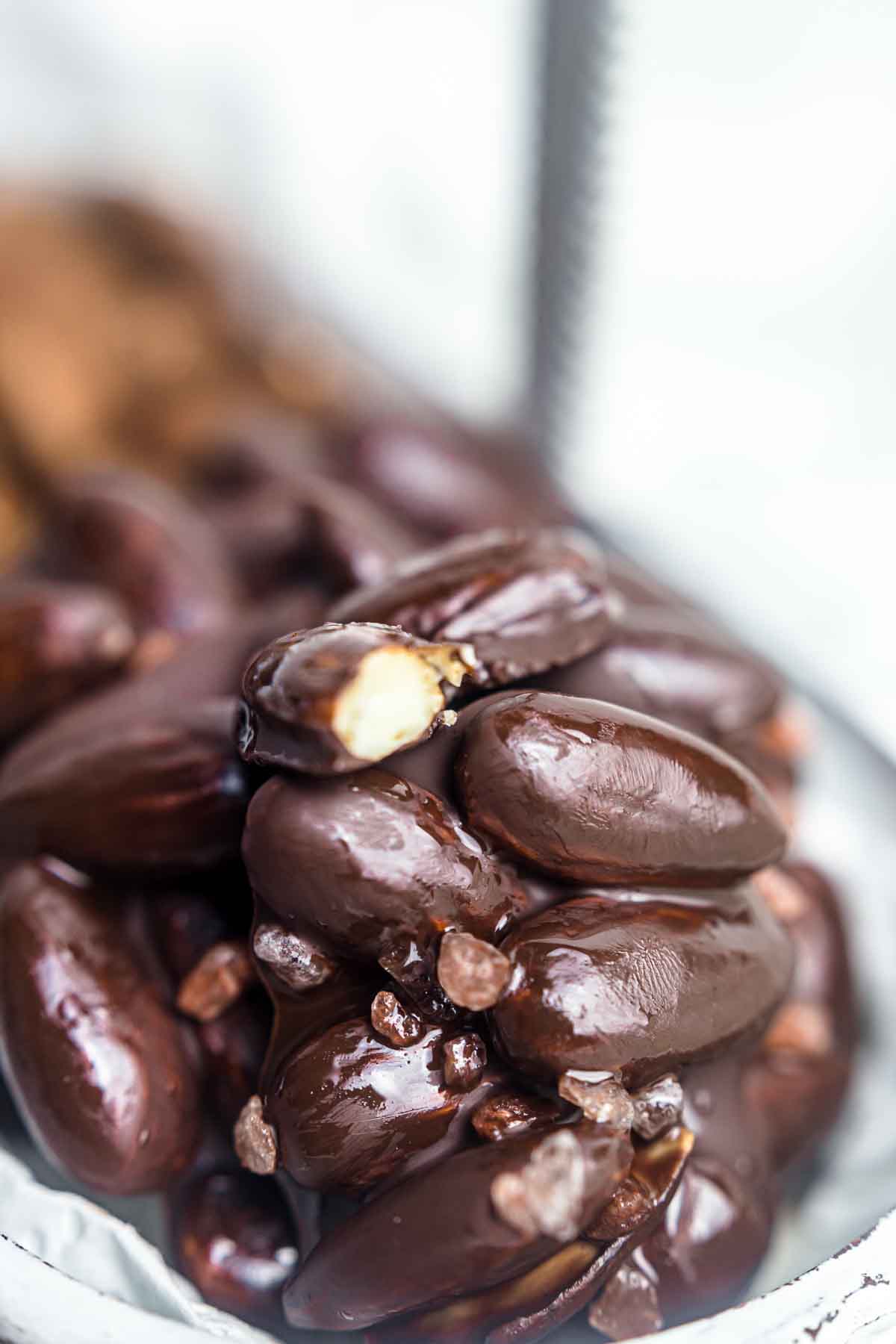 Chocolate covered almonds in a bowl.