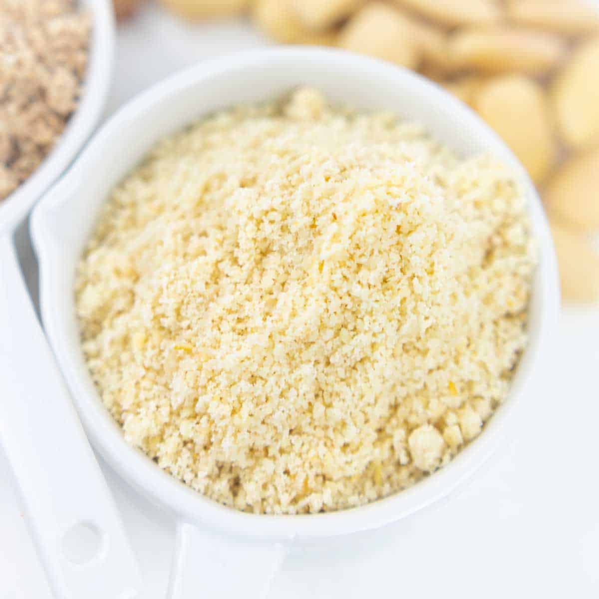 A close-up shot of a white bowl filled with almond flour.