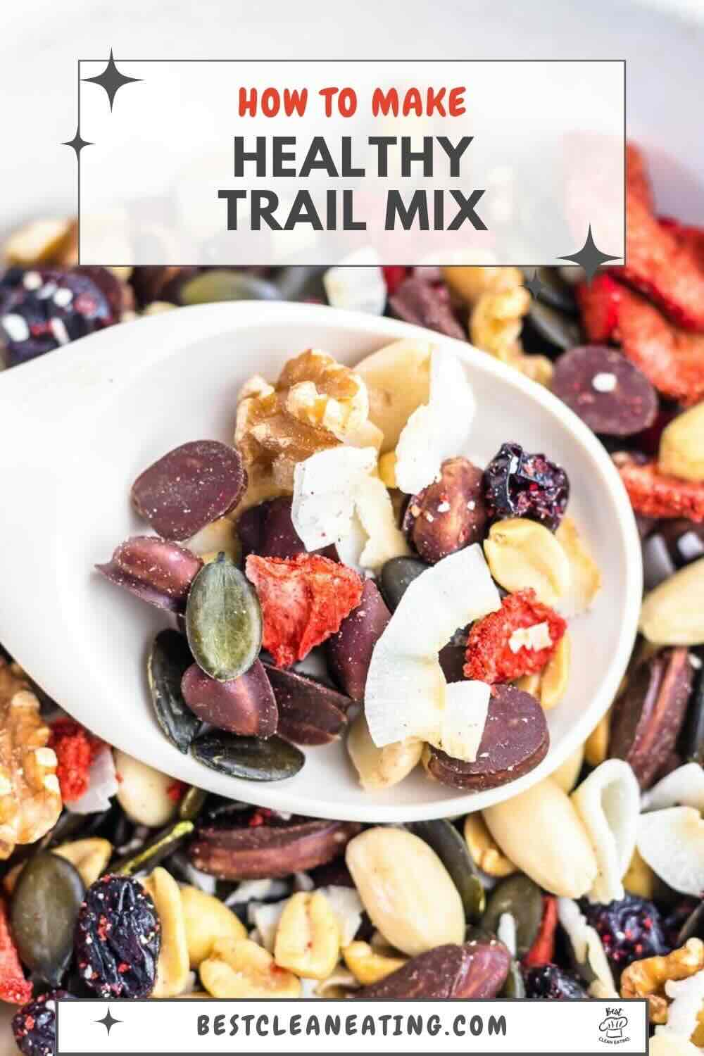 A close-up of a spoonful of healthy trail mix containing nuts, seeds, dried fruits, and chocolate pieces. Text reads "How to Make Healthy Trail Mix" at the top and "BestCleanEating.com" at the bottom.