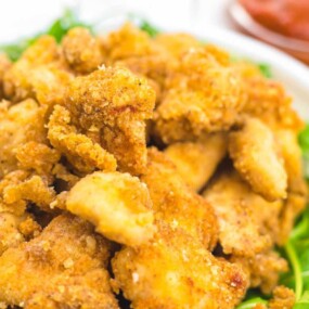 Popcorn chicken on a green leaves.