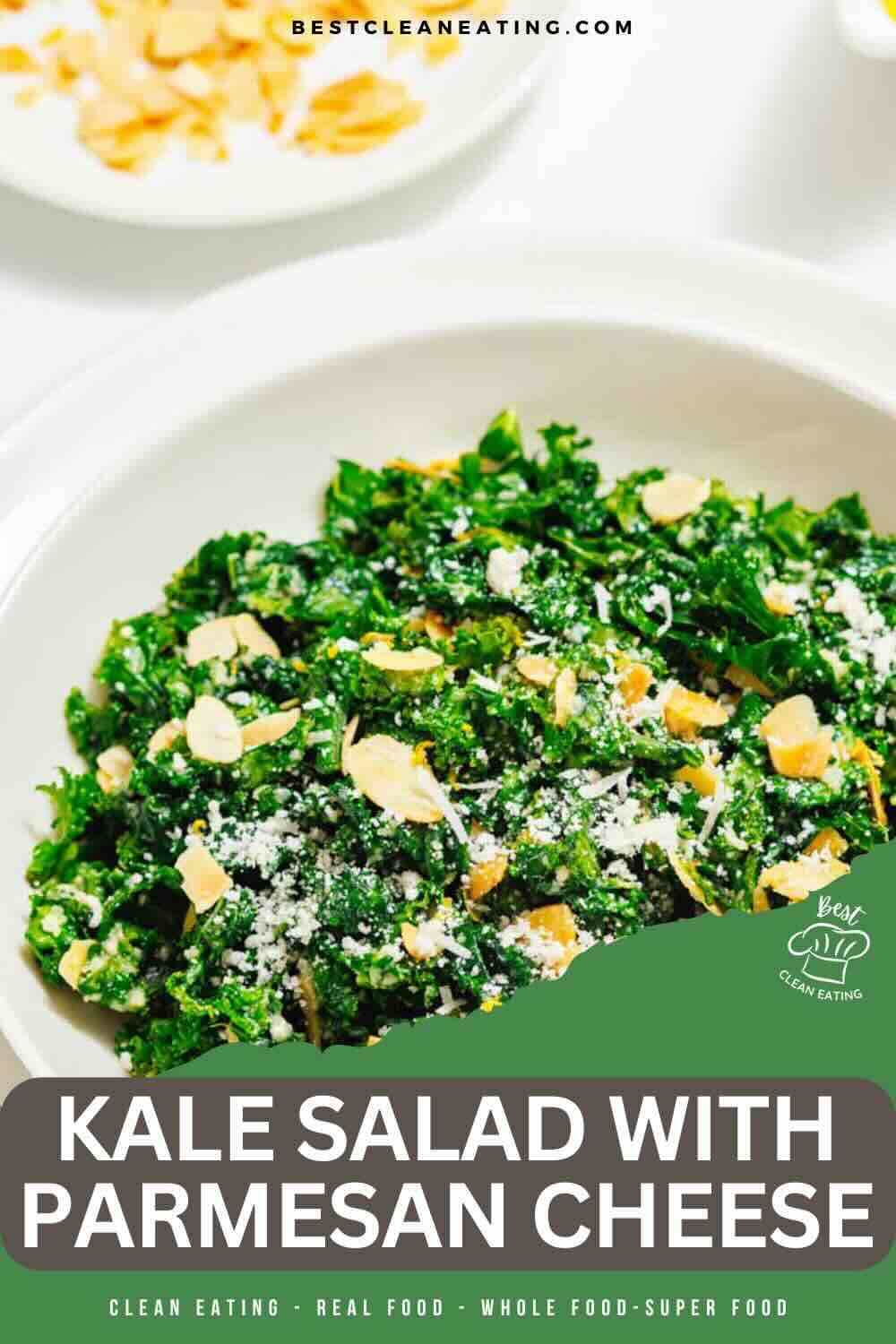 A bowl of kale salad topped with grated parmesan cheese and sliced almonds, placed on a white surface.