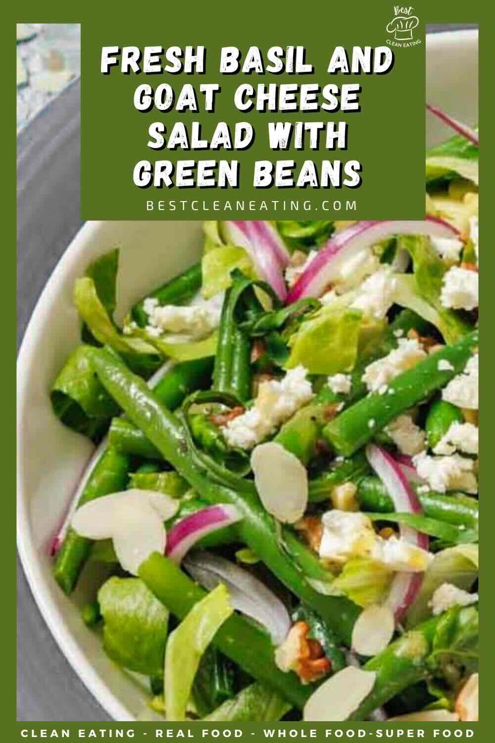 A bowl of salad with green beans, fresh basil, goat cheese, red onions, and almond slices, garnished with leafy greens.