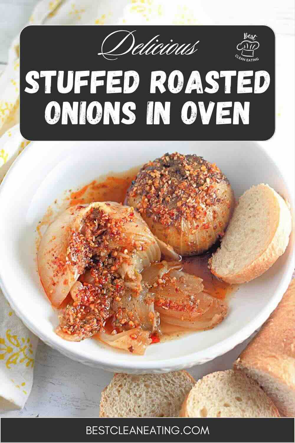 A bowl with two stuffed roasted onions topped with seasoning, served with two slices of bread on the side.