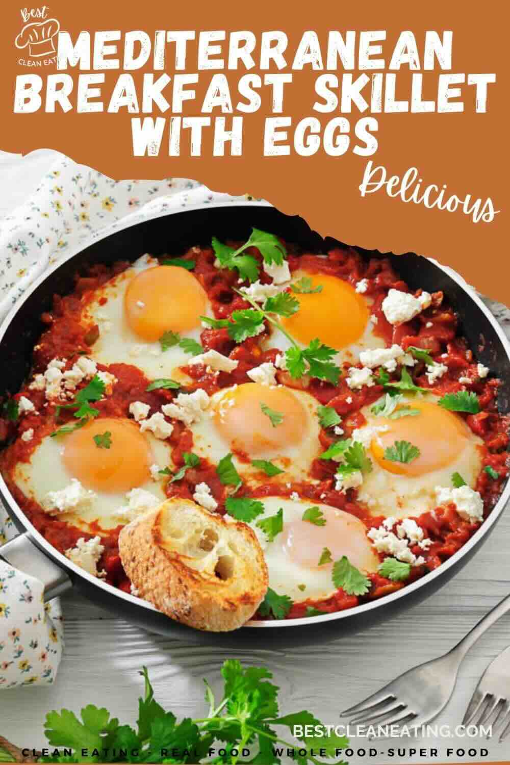 A skillet filled with cooked eggs, tomato sauce, herbs, and feta cheese, with a piece of toasted bread on the edge, labeled as Mediterranean breakfast skillet with eggs.