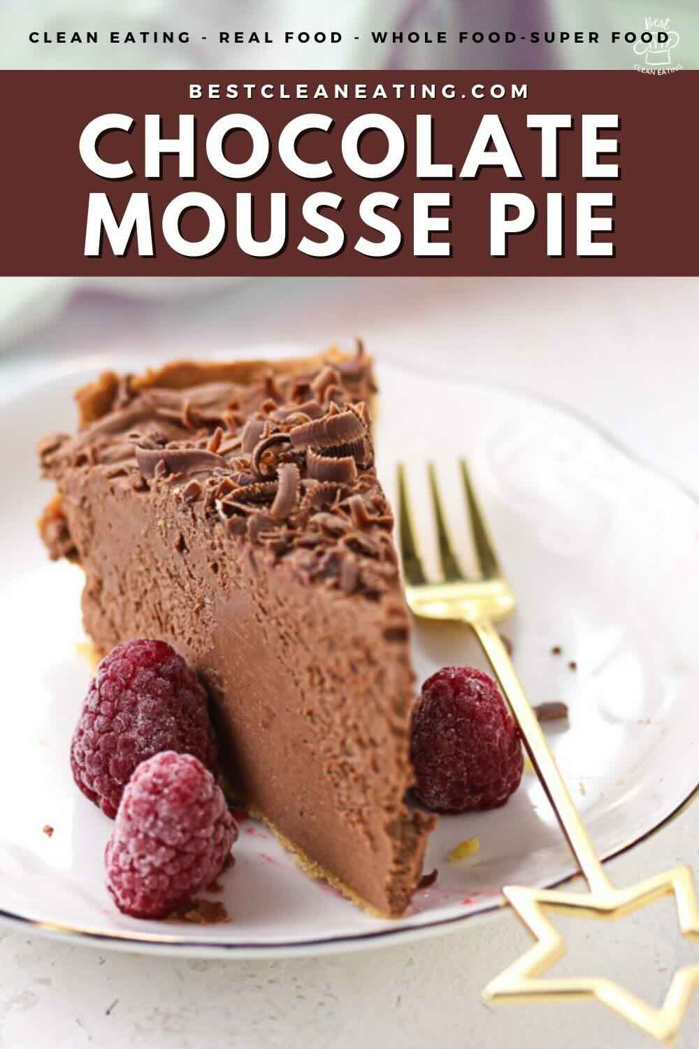 A slice of chocolate mousse pie sits on a white plate with three raspberries, accompanied by a gold fork.